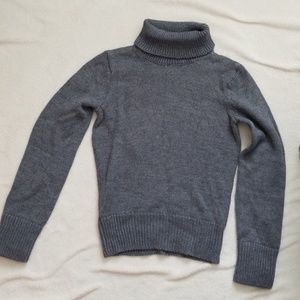 Gray long sleeved turtleneck sweater.